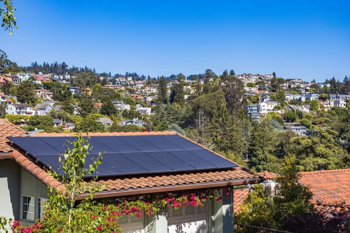 Neighborhood of roofs in Springfield, OR after a storm, where every household is running the same claim process